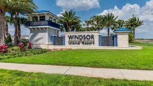 A sign for Windsor Island Resort with a modern building and palm trees. - Luxury Home with Private Pool in Davenport (Davenport)