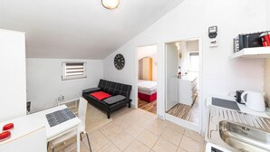 A compact, modern apartment with a kitchenette, a dining area, and a living space. - Amazing Apartment in Labin With Outdoor Swimming Pool, Wifi and 4 Bedrooms (Prgomet)