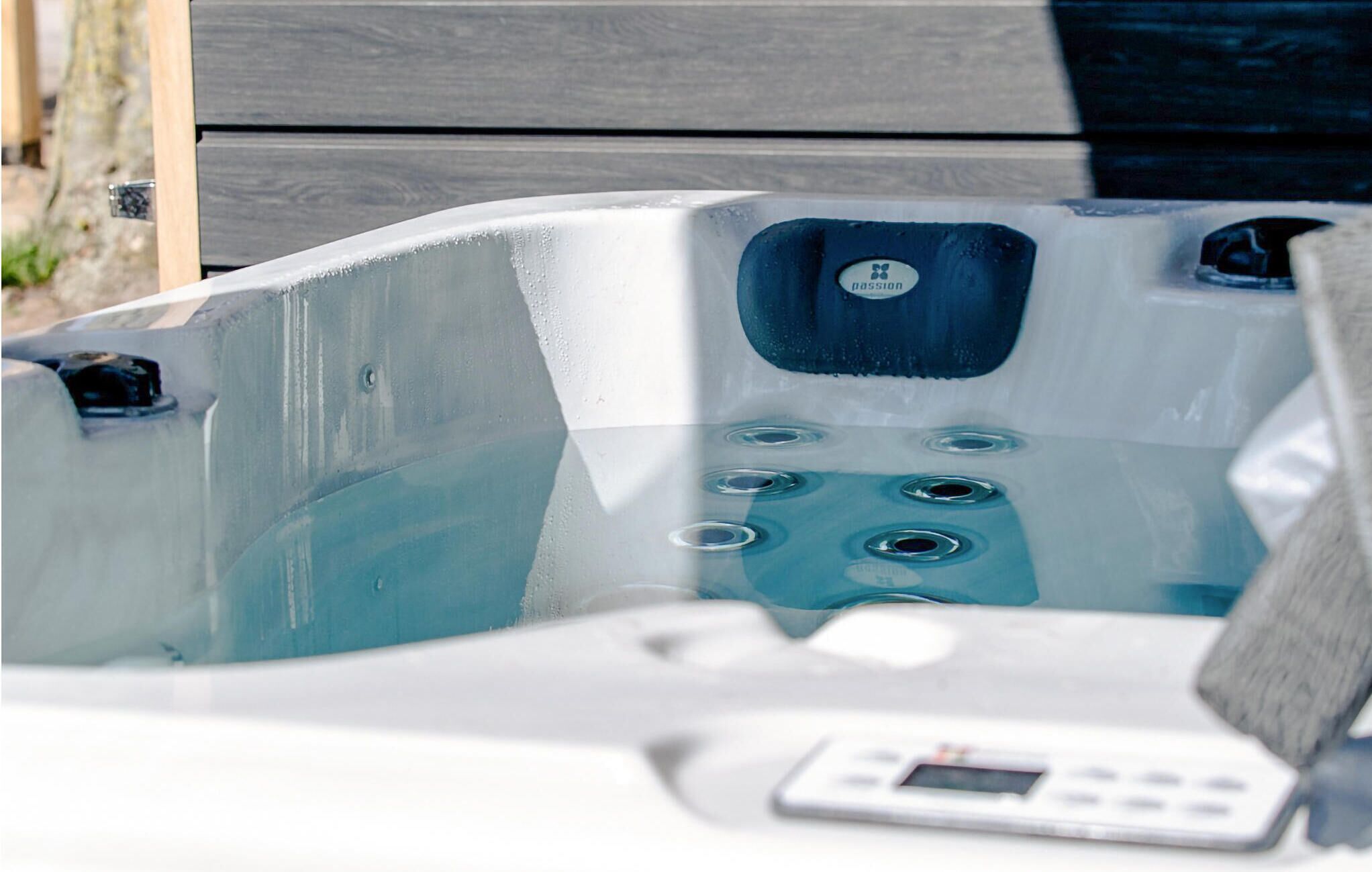 A hot tub with a control panel and a label reading "Passion."