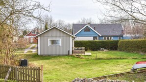 A residential area with a small shed, a blue house, and a red barn. - Beautiful Home in Hasslö With Wifi (Hasslö)