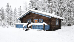 A wooden cabin with a snow-covered roof and a blue porch. - Nice Home in Lima With 1 Bedrooms and Wifi (Lima)