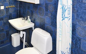 A bathroom with a white sink, toilet, and shower curtain. - Nice Home in Lima With 1 Bedrooms and Wifi (Lima)