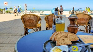 A table with a bottle of Blanc de Namur beer, a glass of beer, and slices of bread. - Amazing Apartment in Oostende With Wifi and 1 Bedrooms (Ostend)