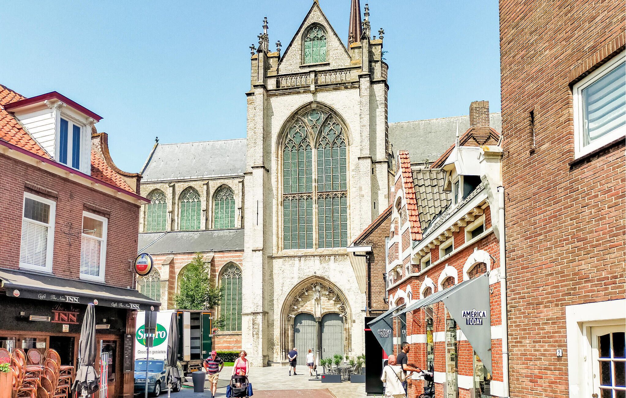 A historic building with large arched windows and a prominent tower.