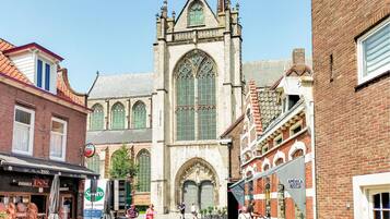 A historic building with large arched windows and a prominent tower.