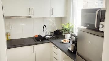 Fridge, electric kettle, toaster, cookware/dishes/utensils