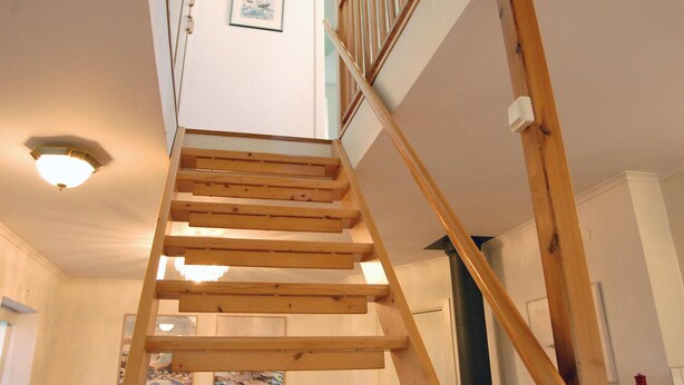 A wooden staircase leading to a landing with a light fixture above. - Stunning Home in Visby With 2 Bedrooms and Wifi (Visby)