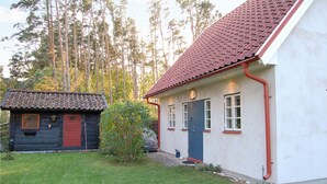 A two-story house with a red-tiled roof and a blue door. - Stunning Home in Visby With 2 Bedrooms and Wifi (Visby)