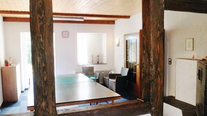 A room with a large table, a mirror, and a radiator.