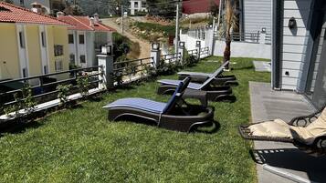 Relax in a serene outdoor seating area with a view of the surrounding mountains.
