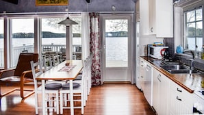 A compact kitchen with a view of a lake, wooden flooring, and basic amenities. - Nice Home in Hyltebruk With 3 Bedrooms, Sauna and Wifi (Hyltebruk)