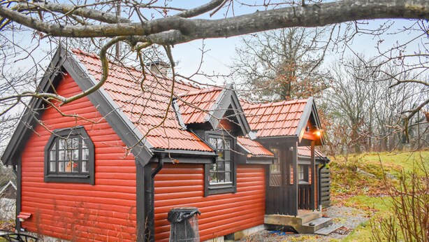 A red wooden house with a sloped roof and black trim. - Beautiful Home in Asarum With (Asarum)