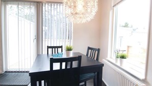 A dining area with a table, chairs, and a decorative light fixture. - Amazing Home in Gotlands Tofta With 2 Bedrooms (Gotlands Tofta)