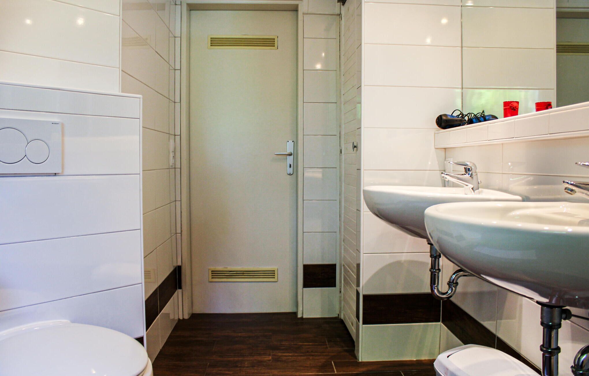 Ein modernes Badezimmer mit Toilette, Bidet und zwei Waschbecken.
