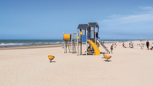 A beach playground with slides and climbing structures, surrounded by sand and the ocean. - Royal Ascot S2 Ref. 8 (Ostend)