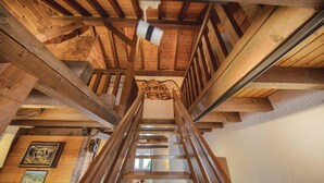 A wooden staircase with a handrail, wooden beams, and a ceiling fan. - Nice Apartment in Schonach With 2 Bedrooms and Wifi (Schonach im Schwarzwald)