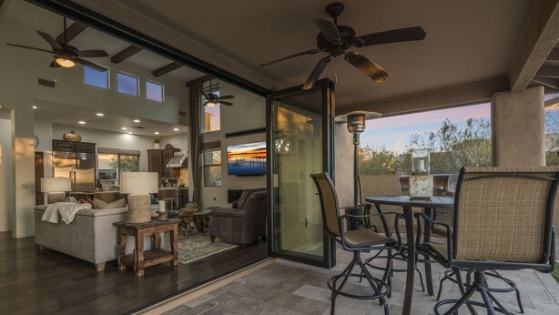 A spacious living area with a ceiling fan, a dining table with chairs, and a large glass door leading to an outdoor patio. - The Boulders Villa-Scottsdale-Private Pool/Spa-Golf⛳️ (Scottsdale)