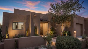 A modern building with a flat roof, a large window, and a door. There are cacti and shrubs in the foreground. - The Boulders Villa-Scottsdale-Private Pool/Spa-Golf⛳️ (Scottsdale)