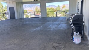 An outdoor covered area with a concrete floor, a barbecue grill, and a propane tank. - Quiet and cozy, a remodeled dairy with panoramic mountain views. . (Salem)