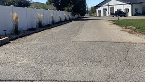 A gravel driveway leading to a building with a white fence and tall grasses. - Quiet and cozy, a remodeled dairy with panoramic mountain views. . (Salem)