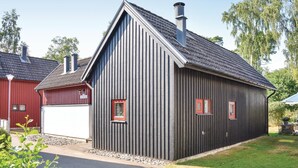 A modern building with a sloped roof and two chimneys. - Klitterbyn 16 (Angelholm)