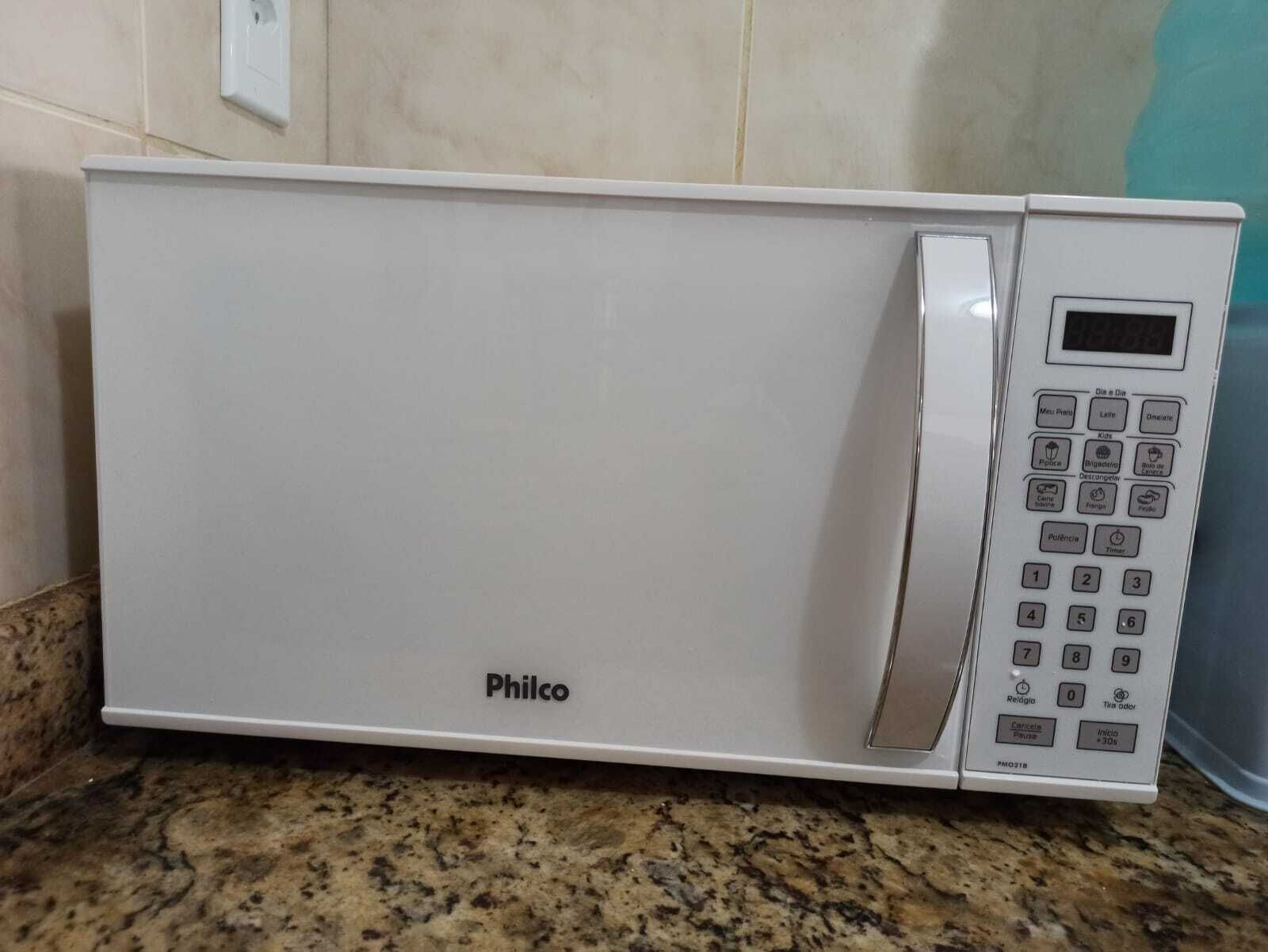 A white Philco microwave oven with a digital display and control panel on a granite countertop.