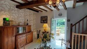 A wooden staircase with a glass door leading to an outdoor deck. - Logis des Fées, spa, swimming pool, air conditioning & garden (Baugé en Anjou)