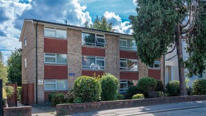 A multi-story residential building with numbered windows and a brick facade. - Spacious Pet Friendly 2-bed Apartment in Redhill (Redhill)