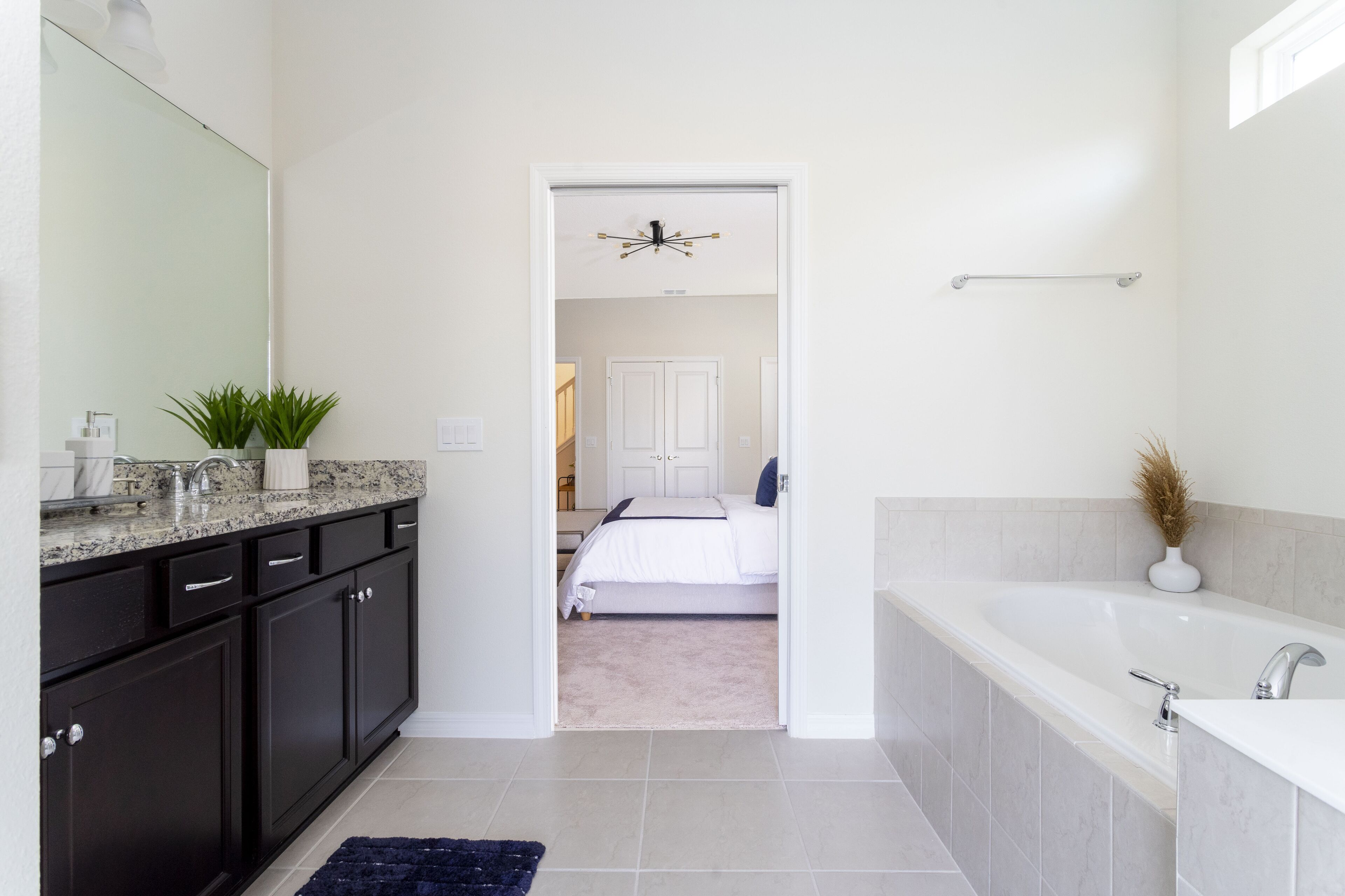 Une salle de bain moderne dotée d’une grande baignoire, d’une douche séparée et d’un meuble-lavabo avec un miroir.