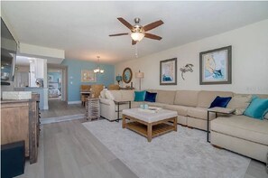 Relax in this inviting living space with a sofa, armchair, and coffee table.