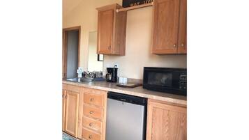 Fridge, microwave, coffee/tea maker, cookware/dishes/utensils