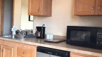 Fridge, microwave, coffee/tea maker, cookware/dishes/utensils
