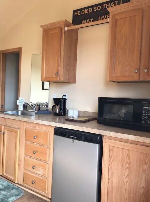 Fridge, microwave, coffee/tea maker, cookware/dishes/utensils