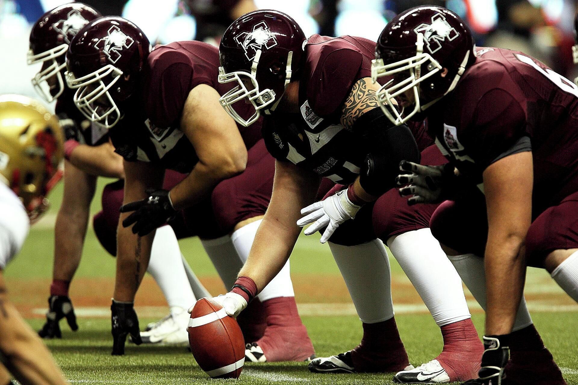 A football team in uniform on a field.