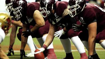 A football team in uniform on a field.