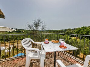 A terrace with a white table, two white chairs, a metal railing, and a view of a vineyard. - Stunning  villa for 16 guests with private pool, WIFI, TV, patio, pets allowed and panoramic view (Scandicci)
