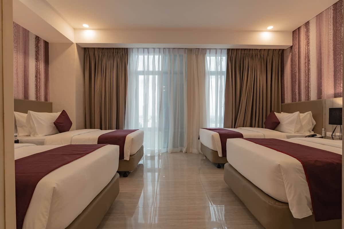 A hotel room with two beds, a large window with curtains, and a modern design.