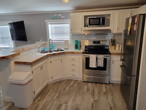 Prepare meals in a well-equipped kitchen with a refrigerator, microwave, and double oven.