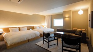 A hotel room with two beds, a sofa, a small table, and a chair. - HOTEL LEPO CHAHAL (Matsuyama)