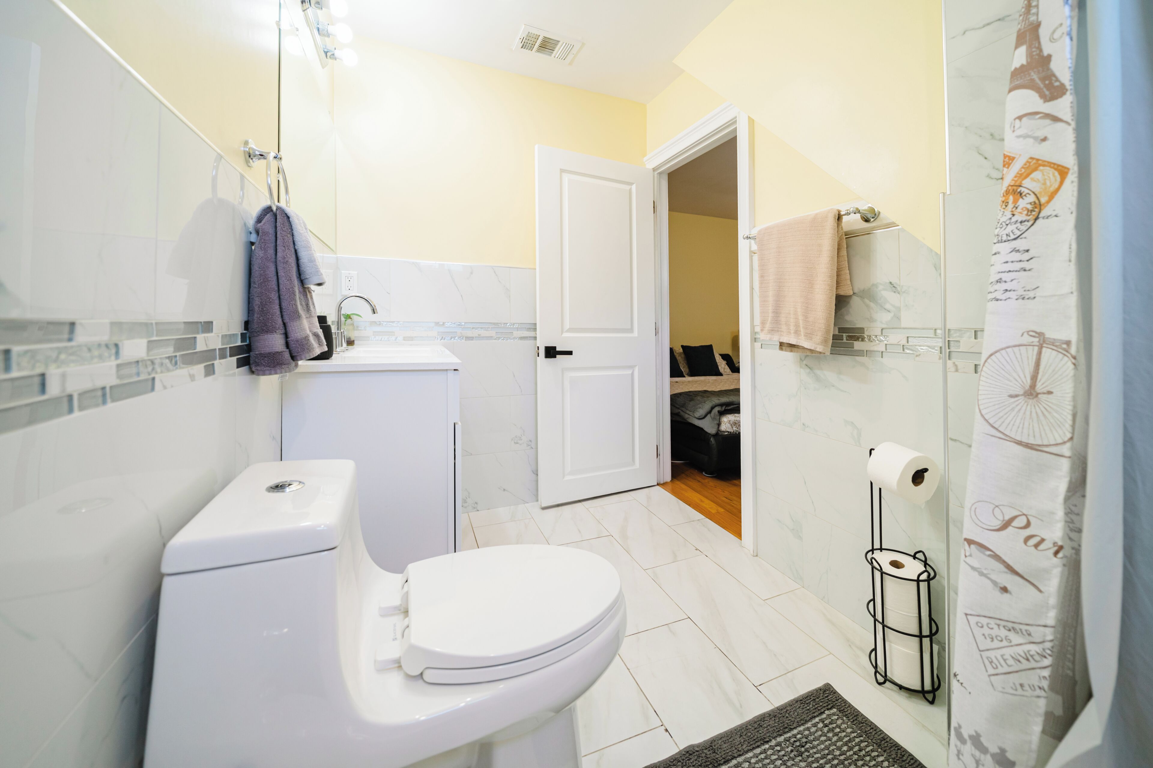A bathroom with a toilet, sink, and shower.