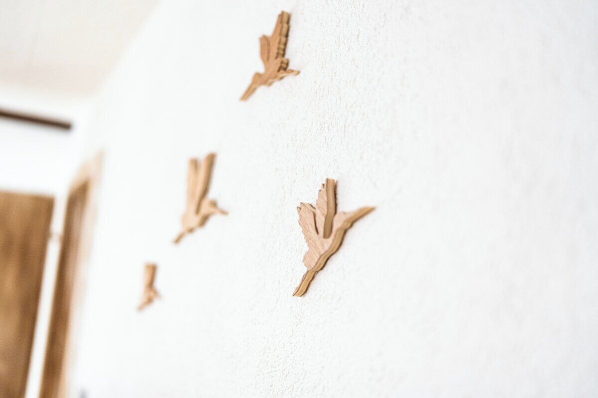 A wall with several wooden leaf decorations.