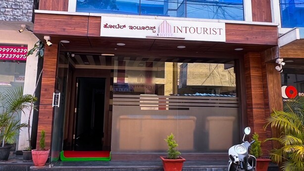 A hotel entrance with a sign reading "INTOURIST HOTEL". - Hotel InTourist by Agira Hotel (Bengaluru)