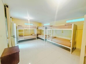 A room with bunk beds, a small desk, and a window with a view. - Rinjani Garden Syariah by ecommerceloka (Sembalun Lawang)