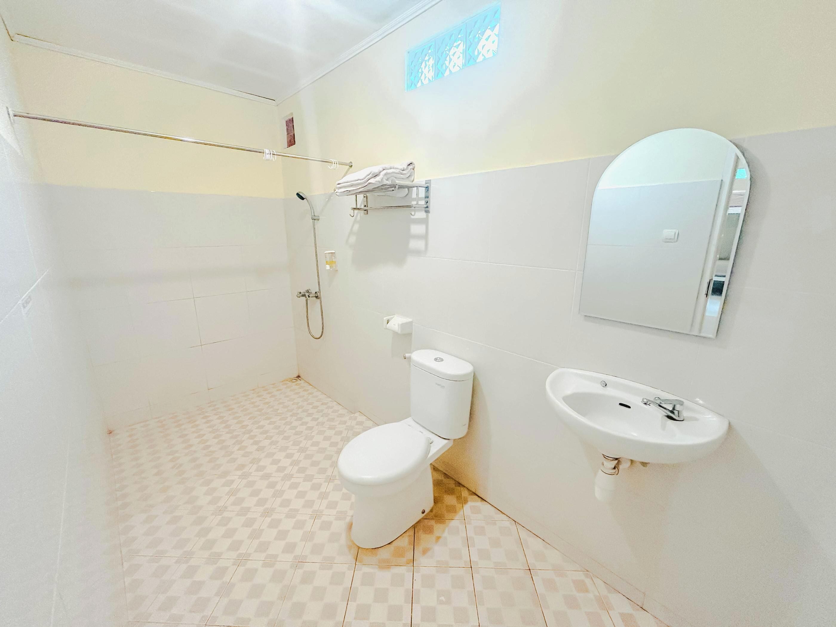 A bathroom with a toilet, a sink, and a shower.