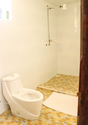 A small bathroom with a toilet, a shower, and a tiled floor. - Stay.Plus Shyrah Glass Cottages (Naivasha)