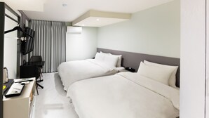 A hotel room with two beds, a desk with a chair, a TV, and a window with curtains. - Lenith Hotel Seomyeon (Busan)