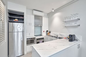 Enjoy cooking in this well-equipped kitchen with an oven, microwave, and coffee machine.