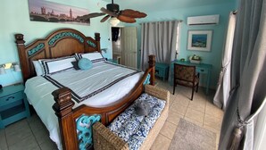 A bedroom with a wooden bed, a ceiling fan, a desk, and a chair. - Luxury Oceanview Pool Eco-friendly Villa Near Key West (Summerland Key)
