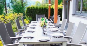 Enjoy a casual meal in our garden courtyard, surrounded by lush greenery and a beautiful building.