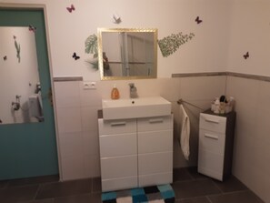 Shower, hair dryer, towels, toilet paper